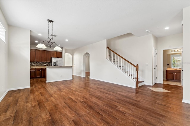 unfurnished living room featuring dark wood-type flooring