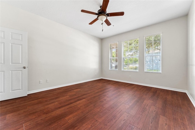 empty room with hardwood / wood-style floors and ceiling fan