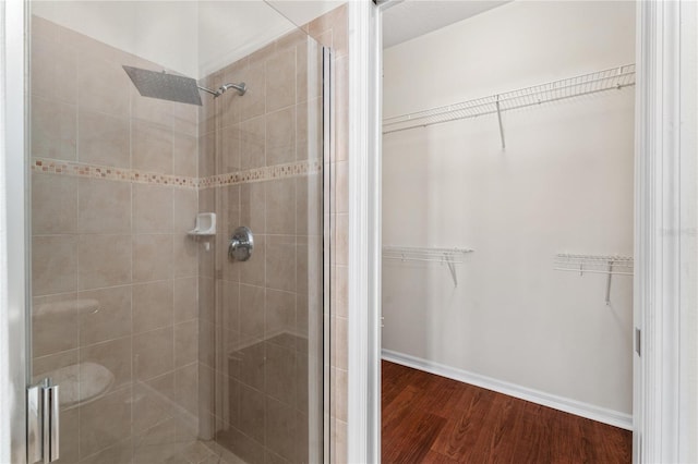 bathroom featuring a shower with door and hardwood / wood-style floors