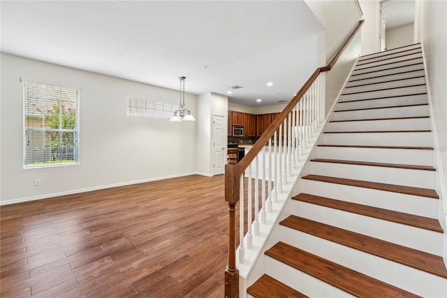 staircase with hardwood / wood-style flooring