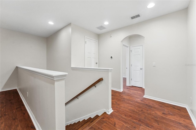 corridor with hardwood / wood-style floors