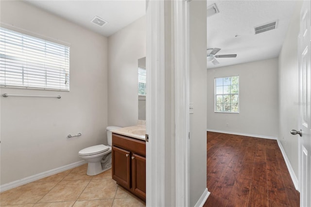 bathroom with ceiling fan, vanity, toilet, and hardwood / wood-style flooring