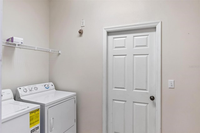 laundry room featuring washing machine and clothes dryer