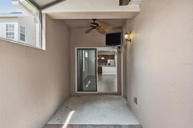 property entrance with ceiling fan