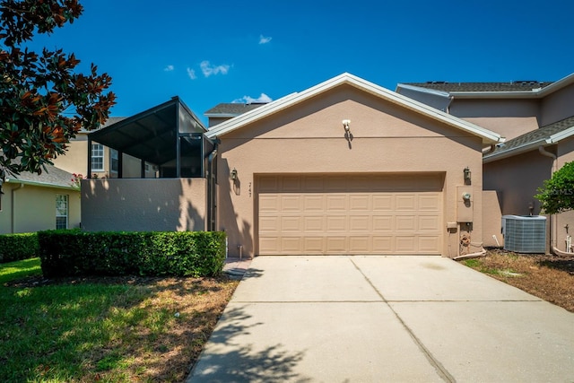 front of property with cooling unit and a garage