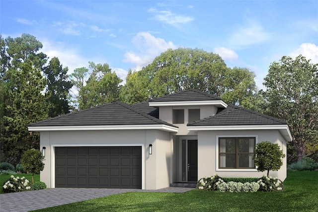 view of front of home with a front lawn and a garage