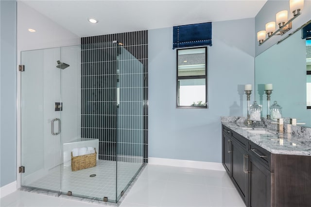 bathroom featuring a shower with door, vanity, and tile patterned flooring