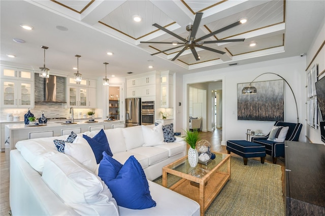 living room with beam ceiling, ceiling fan, wood-type flooring, and coffered ceiling