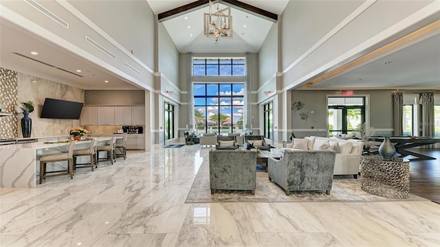 tiled living room with beam ceiling, high vaulted ceiling, french doors, and a chandelier