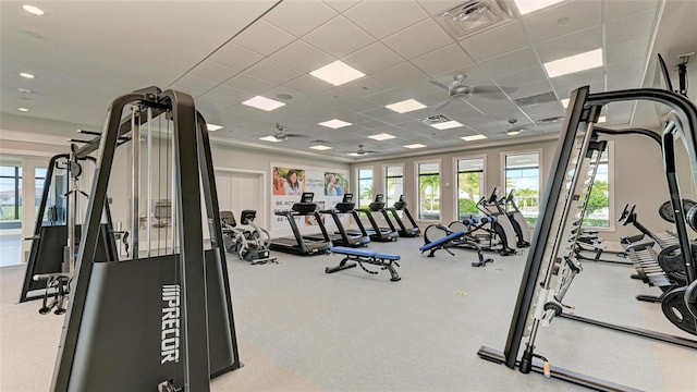 gym with ceiling fan and a drop ceiling