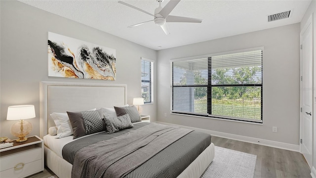 4990 Fairhope Cir, Lakewood Ranch, FL 34211 - bedroom with wood finished floors, baseboards, and a ceiling fan
