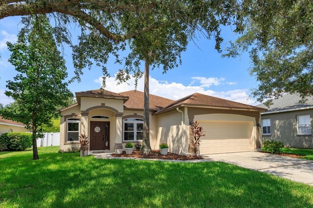 view of front of house featuring a front lawn and a garage