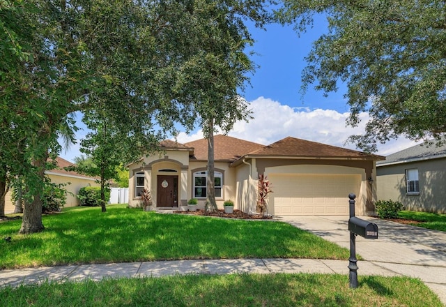 view of front facade with a front yard and a garage