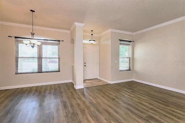 foyer entrance featuring a textured ceiling, plenty of natural light, dark hardwood / wood-style floors, and ornamental molding