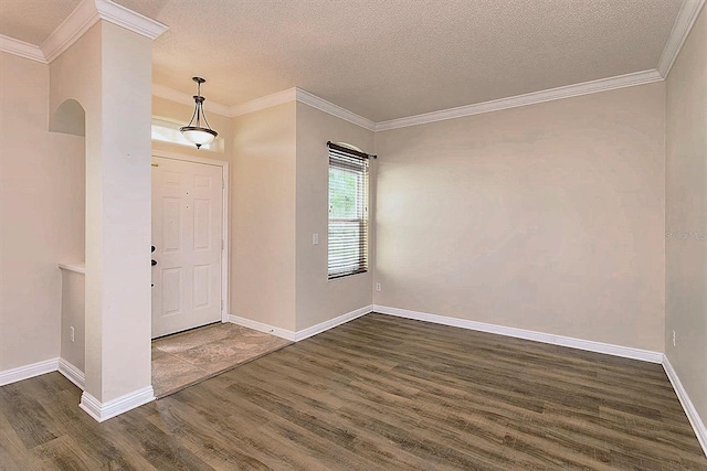 entrance foyer featuring dark hardwood / wood-style floors, ornamental molding, and a textured ceiling