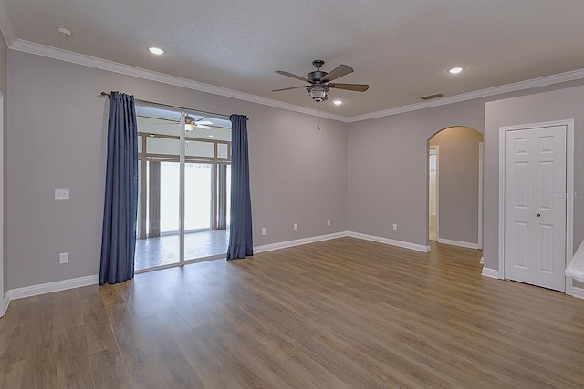 unfurnished room with ceiling fan, crown molding, light wood-type flooring, and a textured ceiling