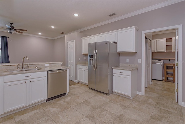 kitchen featuring ceiling fan, white cabinetry, sink, and appliances with stainless steel finishes