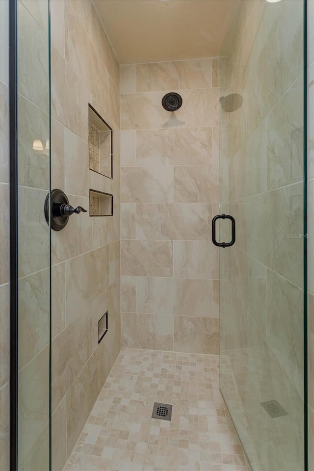 bathroom with a shower with shower door