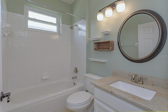 full bathroom featuring tiled shower / bath combo, toilet, and vanity