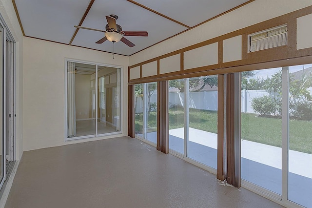 unfurnished sunroom with ceiling fan