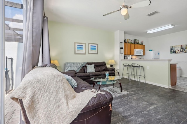 living room featuring dark hardwood / wood-style floors and ceiling fan