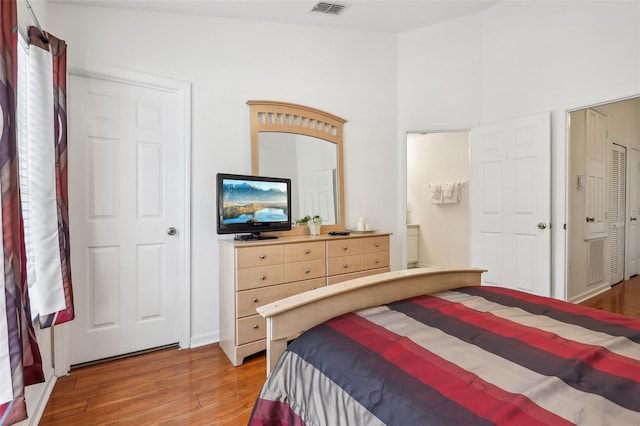 bedroom featuring hardwood / wood-style floors and vaulted ceiling