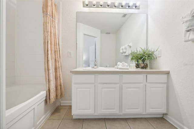 bathroom featuring shower / bath combination with curtain, vanity, and tile patterned flooring