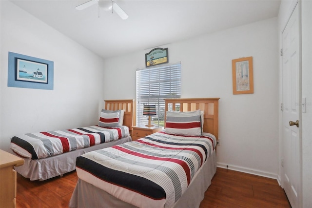 bedroom featuring ceiling fan, vaulted ceiling, and dark wood-type flooring