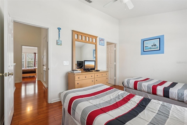 bedroom with dark wood-type flooring and ceiling fan