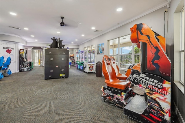 playroom featuring ceiling fan, ornamental molding, and carpet floors