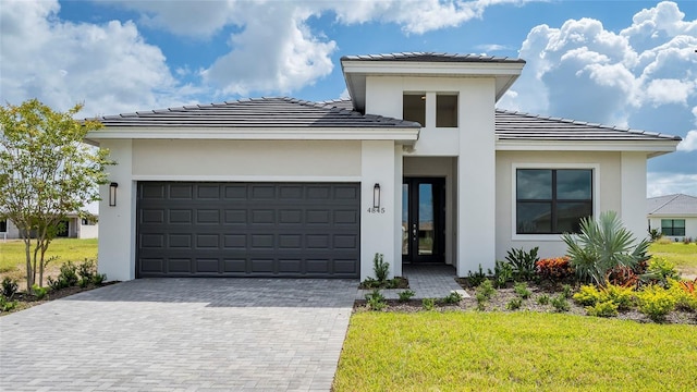 4845 Carova Way, Lakewood Ranch, FL 34211 - prairie-style home featuring a tile roof, stucco siding, an attached garage, decorative driveway, and a front yard
