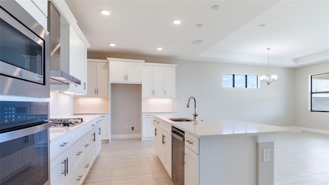 4845 Carova Way, Lakewood Ranch, FL 34211 - kitchen with a sink, stainless steel appliances, backsplash, a chandelier, and recessed lighting