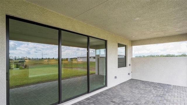 4845 Carova Way, Lakewood Ranch, FL 34211 - unfurnished sunroom featuring plenty of natural light, a textured wall, and a textured ceiling