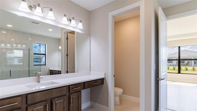 bathroom with walk in shower, vanity, toilet, and plenty of natural light