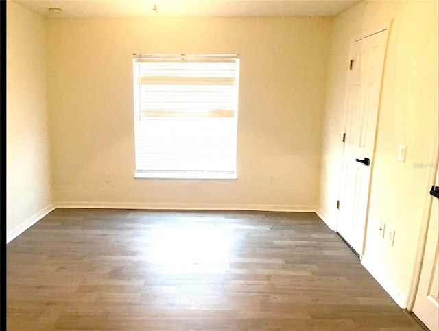 unfurnished bedroom with baseboards and wood finished floors