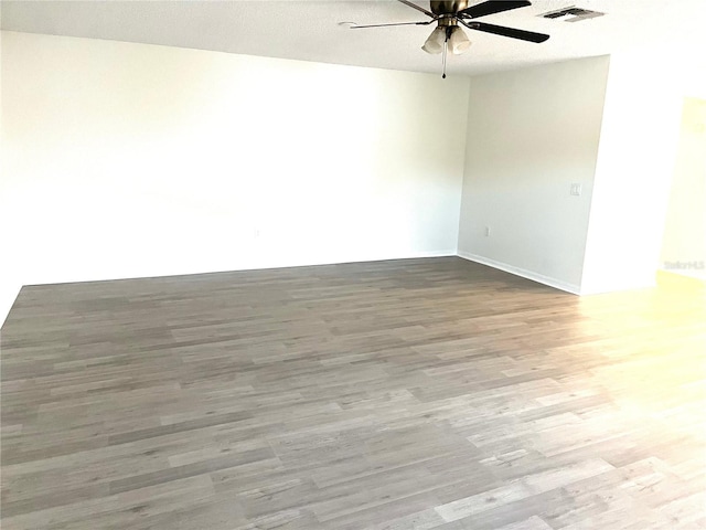 unfurnished room with a textured ceiling, ceiling fan, and hardwood / wood-style floors