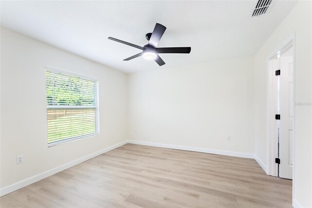 empty room featuring ceiling fan and light hardwood / wood-style flooring