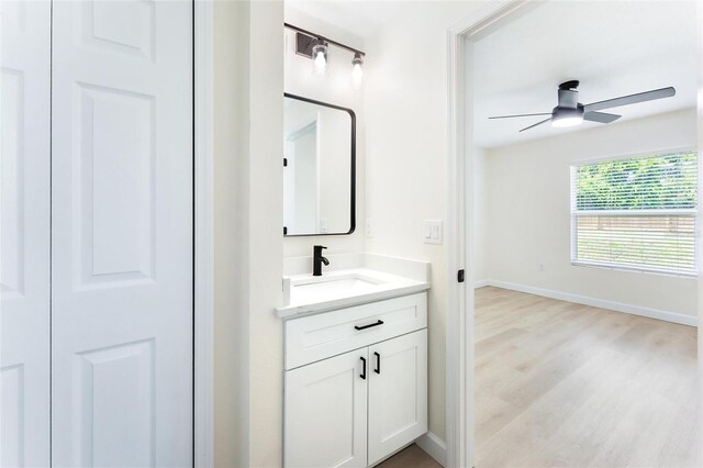 bathroom with ceiling fan, vanity, and hardwood / wood-style flooring