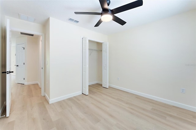 unfurnished bedroom featuring light hardwood / wood-style flooring, ceiling fan, and a closet