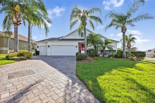 view of front of house with a front yard and a garage