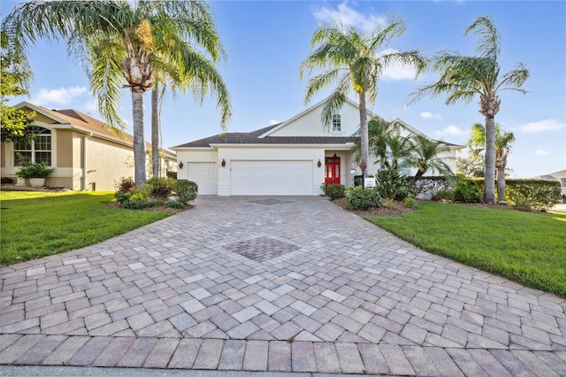 view of front of house featuring a garage and a front lawn