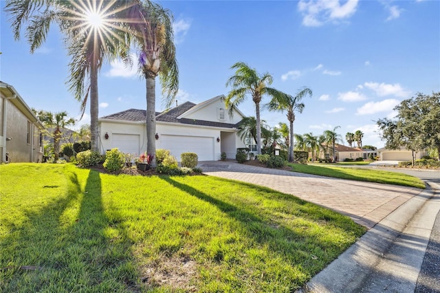 view of front of home with a garage and a front lawn