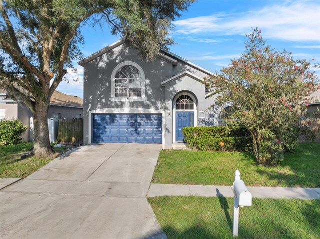 view of front of property featuring a garage and a front yard