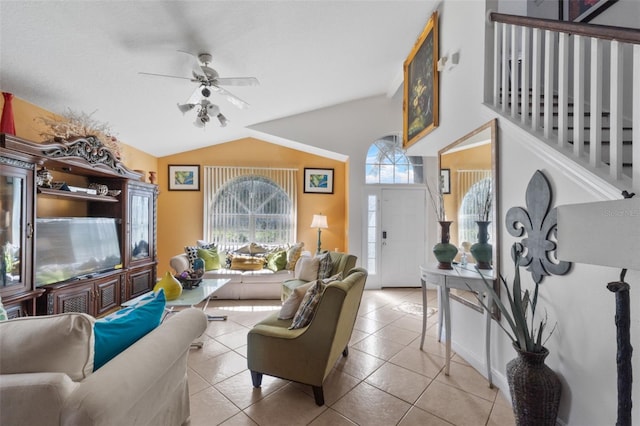 tiled living room featuring ceiling fan and lofted ceiling