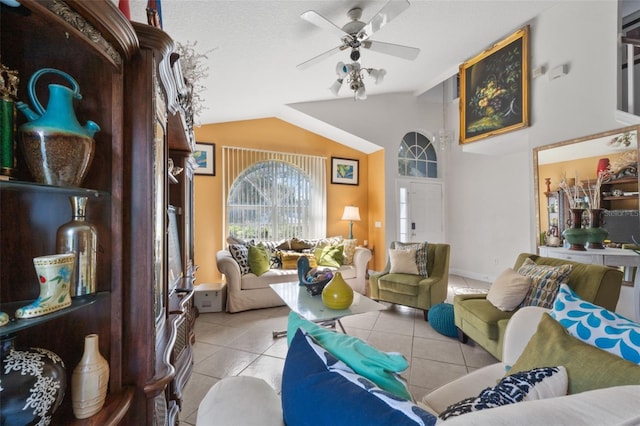 tiled living room featuring ceiling fan and vaulted ceiling