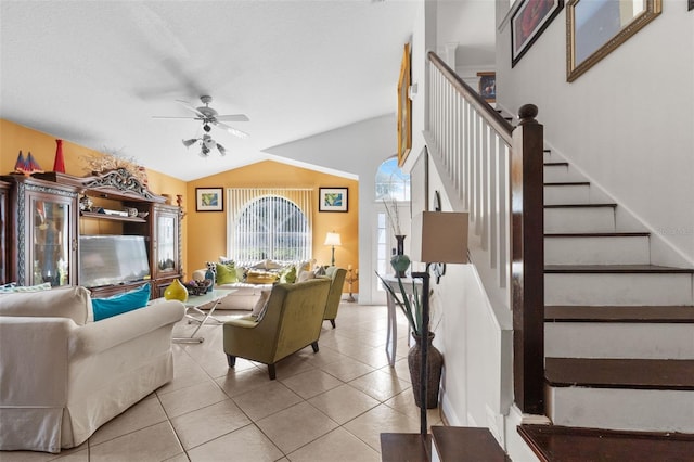 tiled living room featuring ceiling fan and lofted ceiling