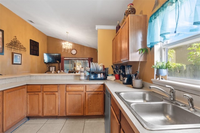 kitchen with an inviting chandelier, sink, light tile patterned floors, kitchen peninsula, and vaulted ceiling