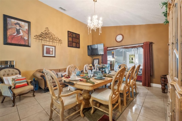 dining area featuring vaulted ceiling, a chandelier, and light tile patterned floors