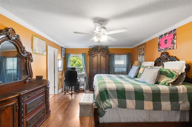 bedroom featuring ceiling fan, a textured ceiling, light hardwood / wood-style flooring, and crown molding