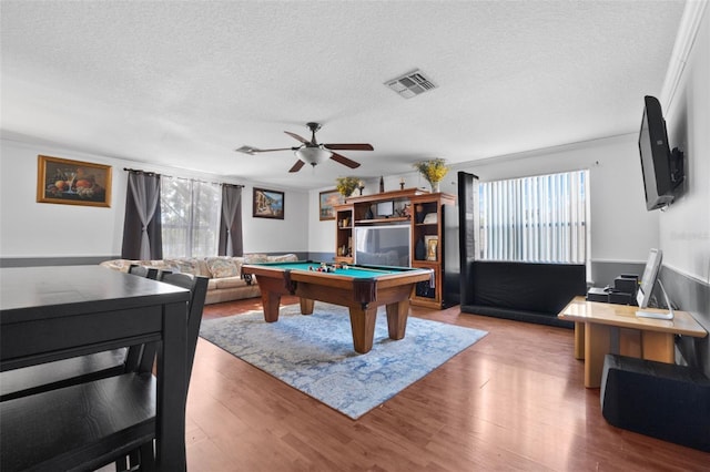 recreation room featuring ceiling fan, pool table, ornamental molding, hardwood / wood-style flooring, and a textured ceiling